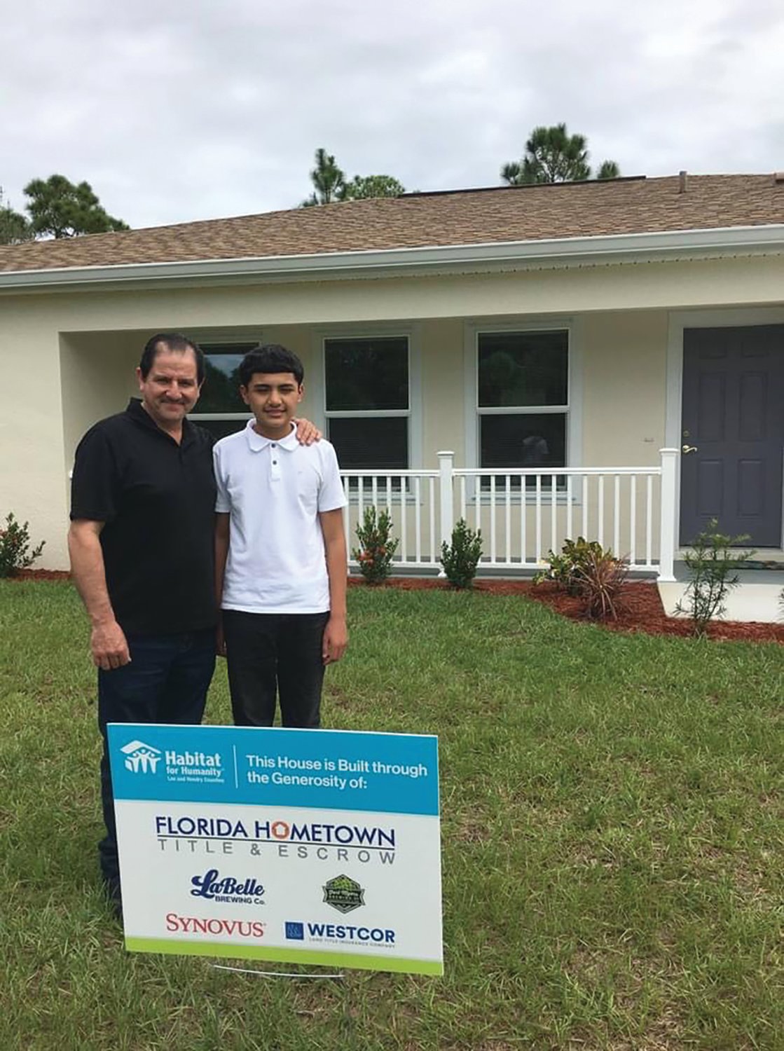 LABELLE — Jorge and his son Enrique receive the keys to their new home.